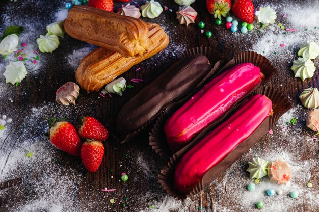 Traditional French dessert eclairs with glaze on candy table