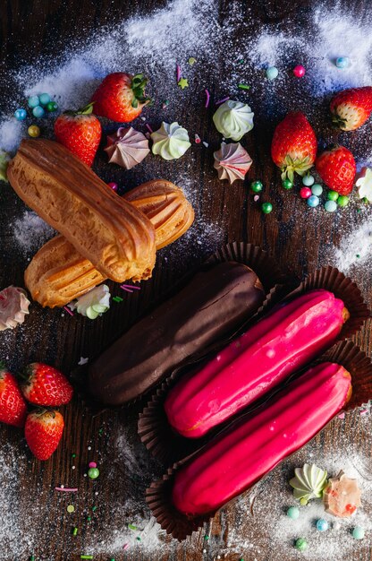 Traditional French dessert eclairs with glaze on candy table