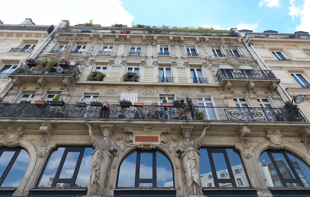 Traditional French house with typical balconies and windows Paris