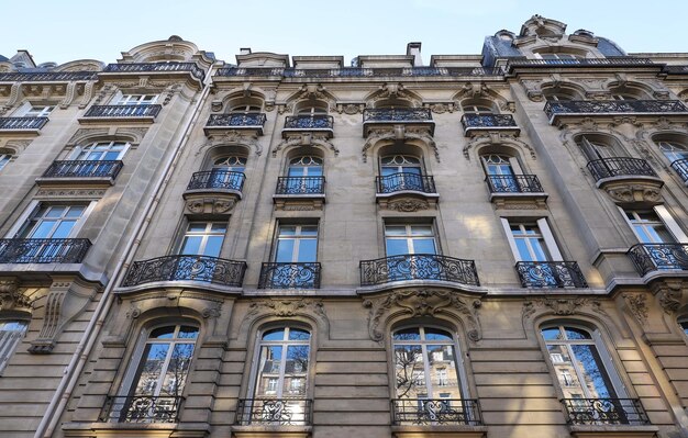 Traditional French house with typical balconies and windows Paris