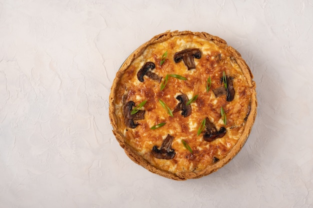 Traditional French pie quiche with mushrooms and cheese