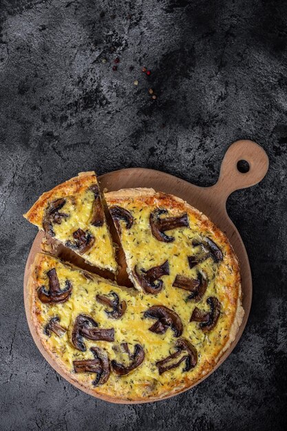 Traditional french quiche pie with chicken and mushroom large\
tart with mushroom pie french cuisine vertical image place for text\
top view