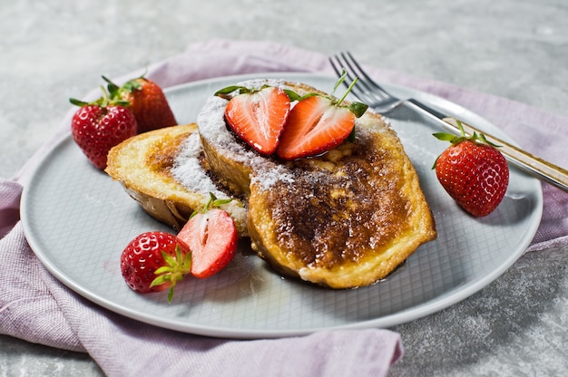 Traditional French toast with strawberries on . 