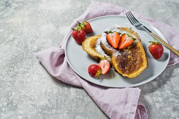 Traditional French toast with strawberries on . 