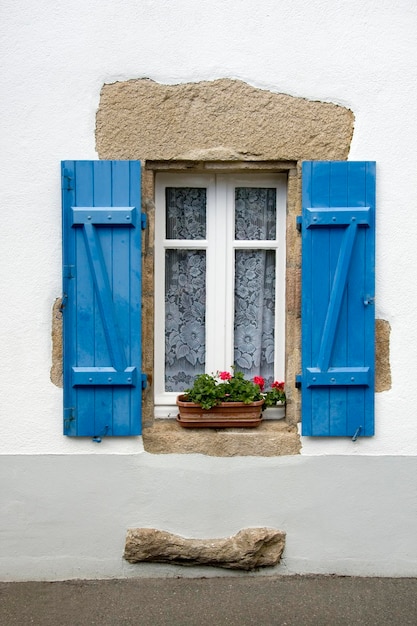 Traditional French window with blue shutters