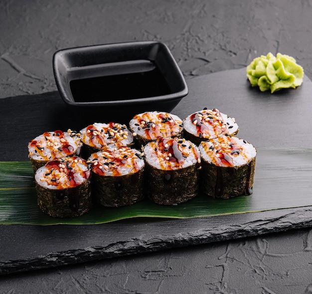 Traditional fresh japanese sushi futomaki on black stone