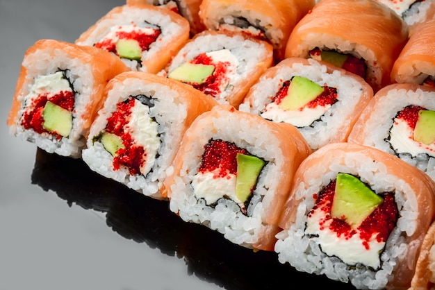 Traditional fresh japanese sushi rolls on a black background