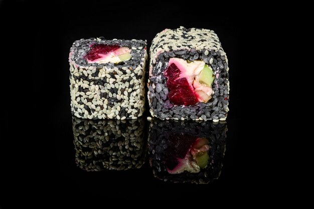 Traditional fresh japanese sushi rolls on a black background