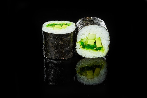 Traditional fresh japanese sushi rolls on a black background