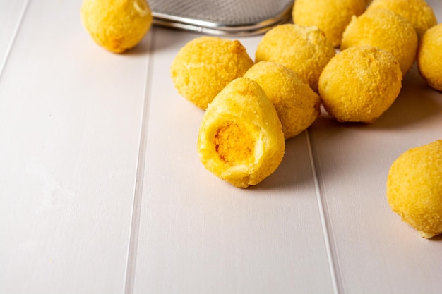 traditional fried coxinha over table, also some cheese balls