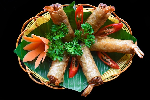 Traditional fried vietnamese spring rolls with shrimps and\
pork, rice paper on black background