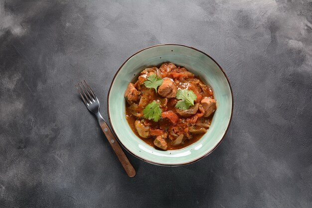 Traditional Georgian dish with chicken and tomato sauce