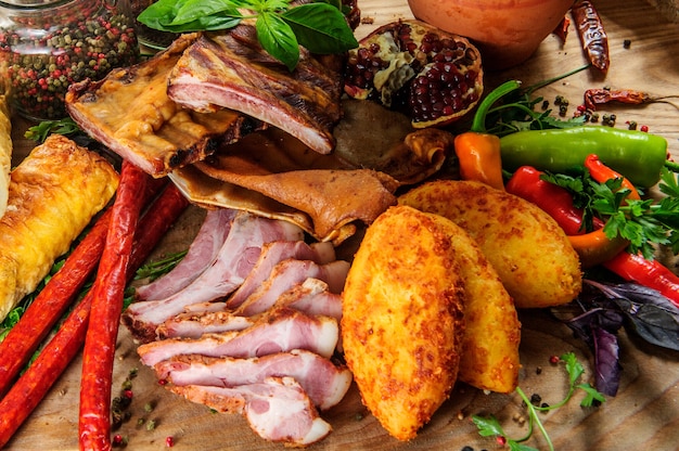 Traditional Georgian meat dishes on wooden background.