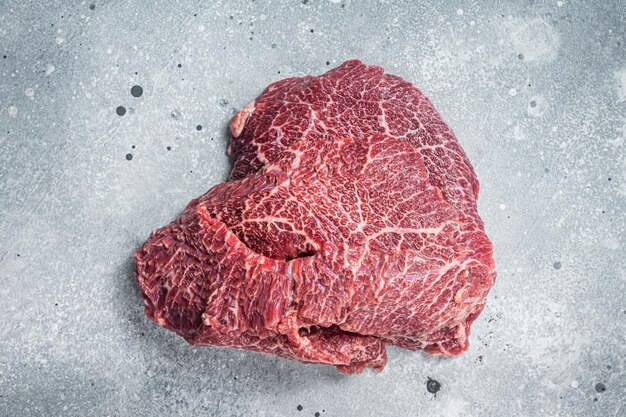 Traditional German raw beef cheeks on butcher table Gray background Top view