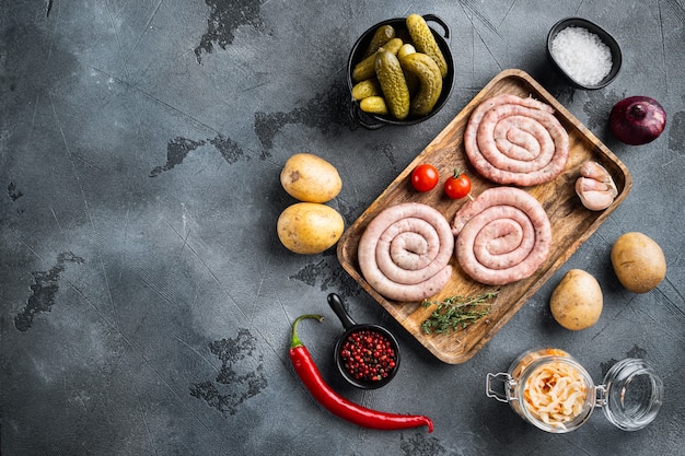 Traditional German Sausages with Mashed Potatoes and Sauerkraut, on gray background, top view flat lay , with space for text  copyspace