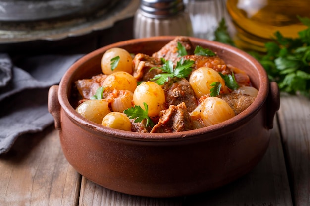 Traditional greek dish of beef stifado in a sauce. meat stew,\
onion stew. turkish name; sogan yahni or et yahni