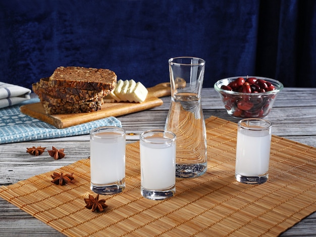 Traditional greek ouzo in shot glasses with appetizers