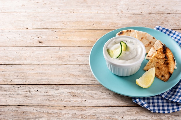 Traditional Greek Tzatziki on wooden table