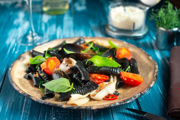 Traditional handmade italian black pasta with seafood