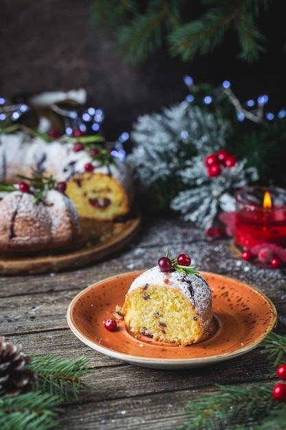 Traditional homemade christmas cake  with cranberry and chocolate with new year tree