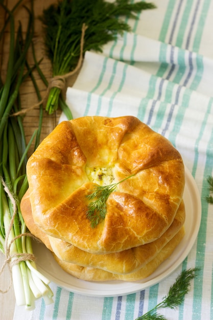 Traditional homemade Romanian and Moldovan pies - Placinta, served with wine. Rustic style.