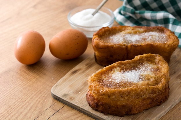 Traditional homemade Spanish torrijas on wooden surface Easter dessert.