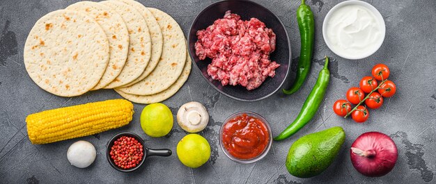 Traditional homemade taco ingredients, over grey