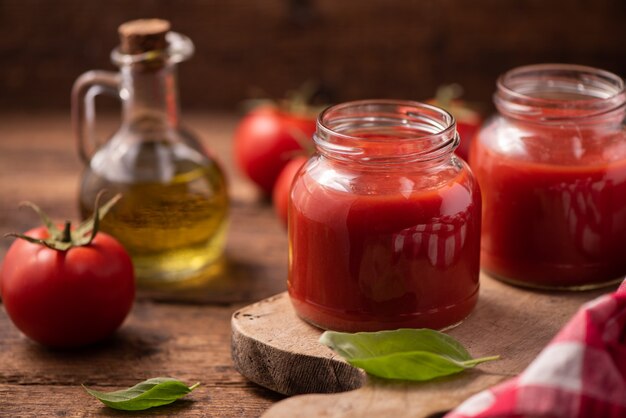 Traditional homemade tomato sauce and tomatoes. Close up