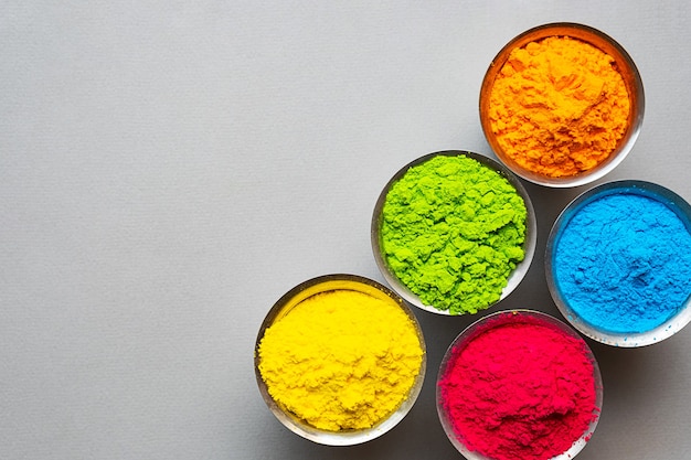 traditional indian colorful holi powder paint  in steell bowls happy holi festival