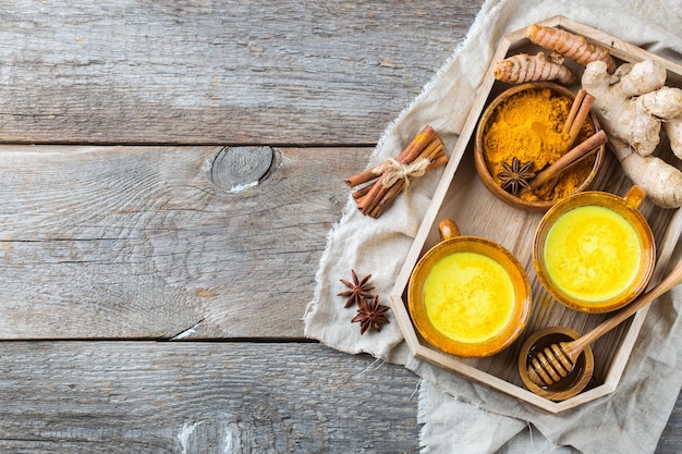 Traditional indian drink turmeric curcuma golden milk with ingredients