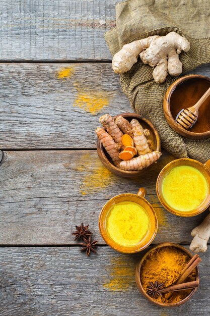 Traditional indian drink turmeric curcuma golden milk with ingredients