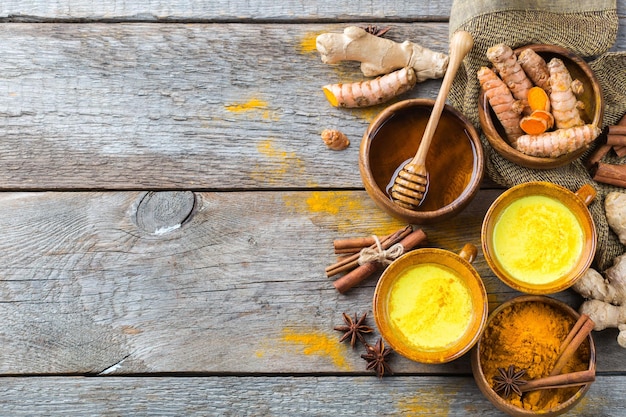 Traditional indian drink turmeric curcuma golden milk with ingredients