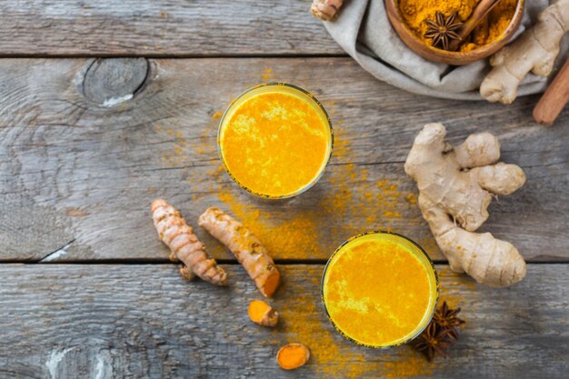 Traditional indian drink turmeric curcuma golden milk with ingredients