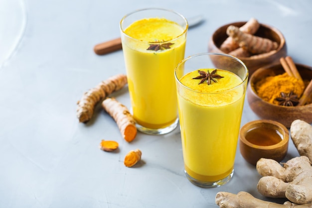 Traditional indian drink turmeric curcuma golden milk with ingredients