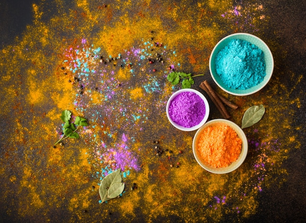 Traditional Indian Holi colours powder, spices, rustic background.