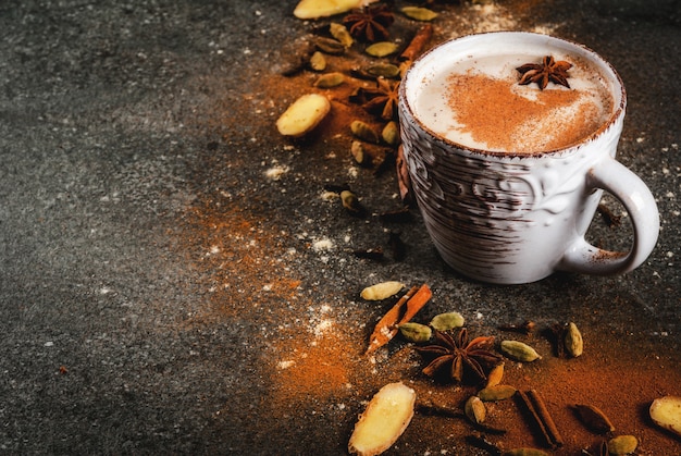 Traditional indian masala chai tea with spices  cinnamon, cardamom, anise, dark stone .