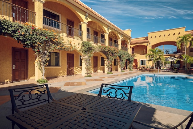 Traditional inner yard of a mexican mansion with a turquoise swimming pool