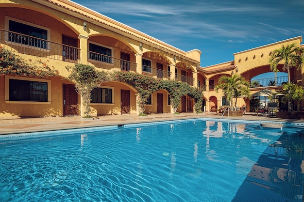Traditional inner yard of a mexican mansion with a turquoise swimming pool