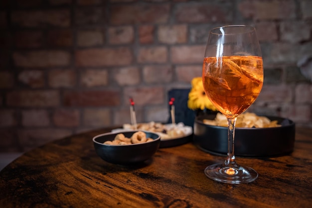 Traditional italian aperitif with cheese nuts and aperol spritz drink