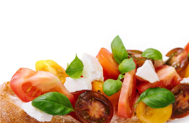 Traditional italian bruschetta with cherry tomatoes and basil leaves