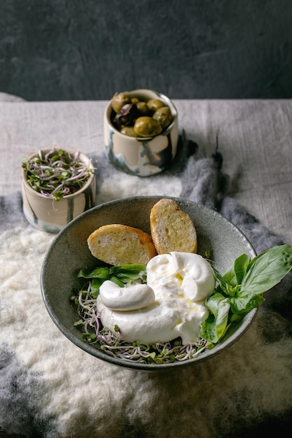 Traditional italian burrata knotted cheese in bowl