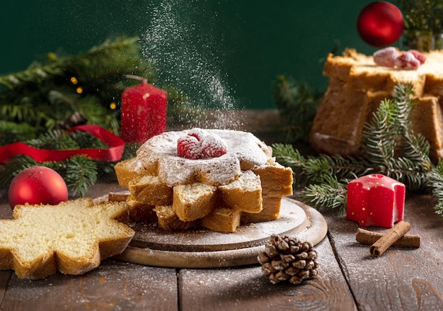 Traditional Italian Christmas cake Pandoro cut in slices on wooden table with Christmas decor