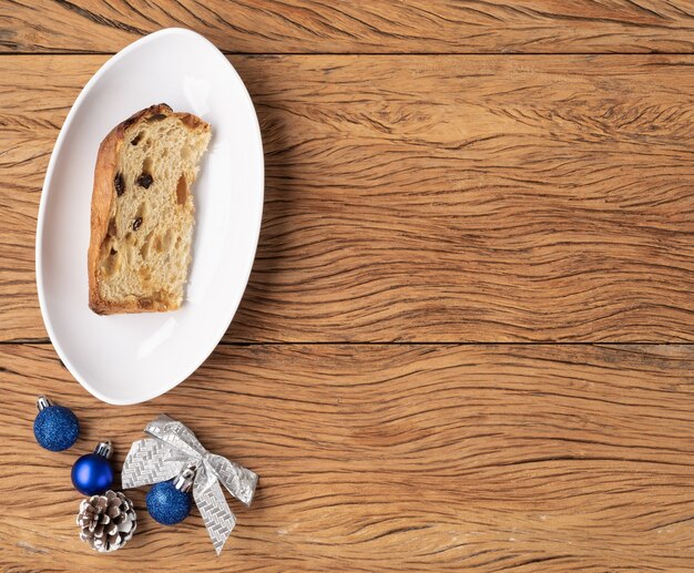 Traditional italian christmas fruit cake panettone sliced and christmas decoration with copy space.