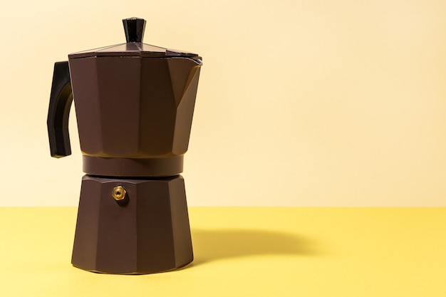 Traditional Italian Coffee Maker with high contrast light on colored backgrounds