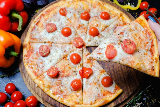 Traditional italian cuisine. delicious pizza slice with melted cheese and cherry tomatoes