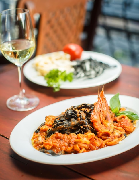 Traditional Italian dish black tagliatelle with seafood
