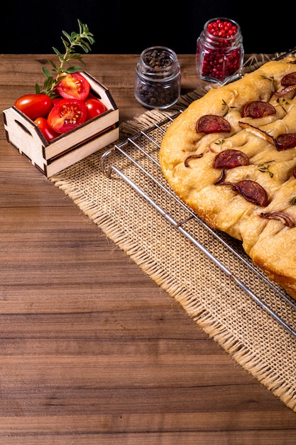 Traditional Italian Focaccia with pepperoni, cherry tomatoes, black olives, rosemary and onion