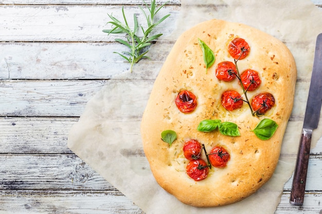 Traditional italian focaccia with tomatoes and rosemary
