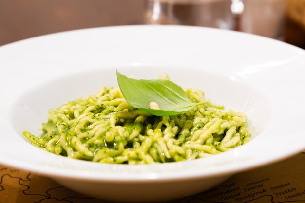 Photo traditional italian food trofie al pesto typical regional pasta from liguria region basil sauce