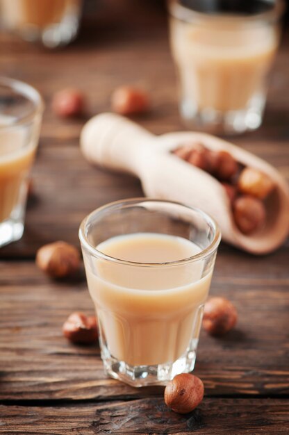 Traditional Italian hazelnut liqueur on the wooden table